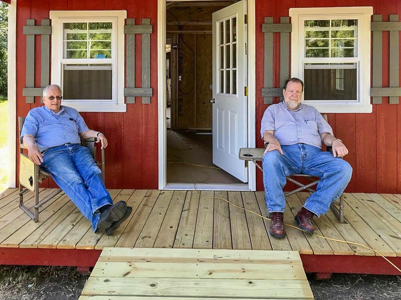 Joe Reed and myself relaxing on the porch of his new storage building.